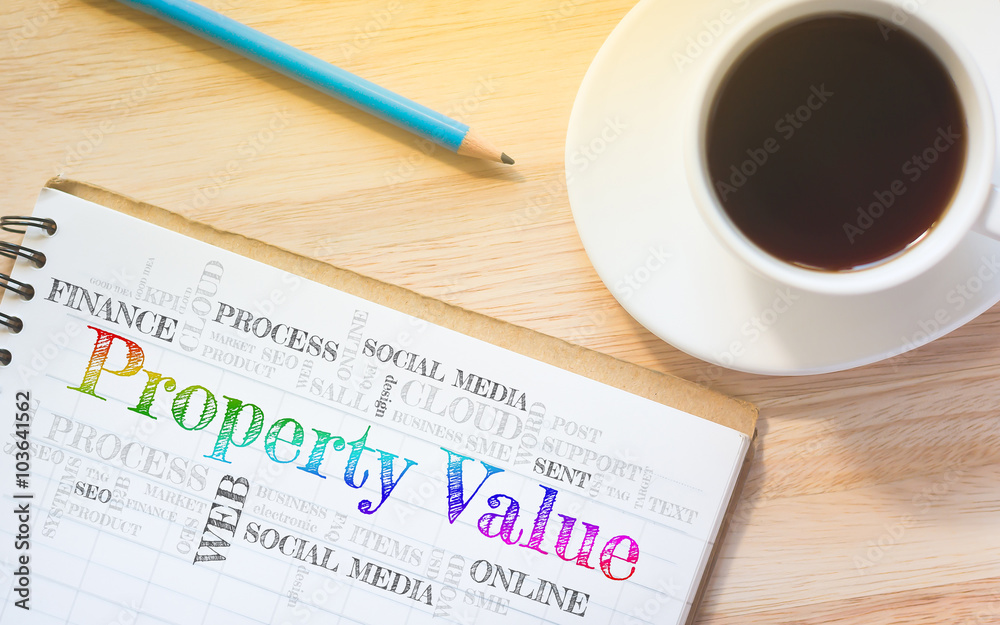 Concept Property Value message on book. A pencil and a glass coffee table.Vintage tone. Concept Property Value message on book. A pencil and a glass coffee table.Vintage tone.