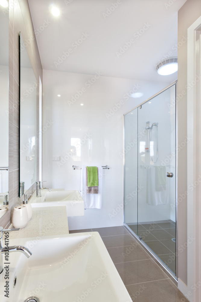Closeup of a modern washstand with a silver faucet near mirror i Closeup of a modern washstand with a silver faucet near mirror i
