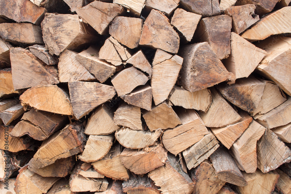 Background of chopped firewood stacked up on top of each other in a pile Background of chopped firewood stacked up on top of each other in a pile