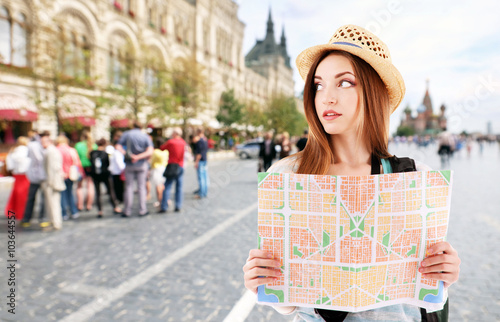 Traveler with map on street...