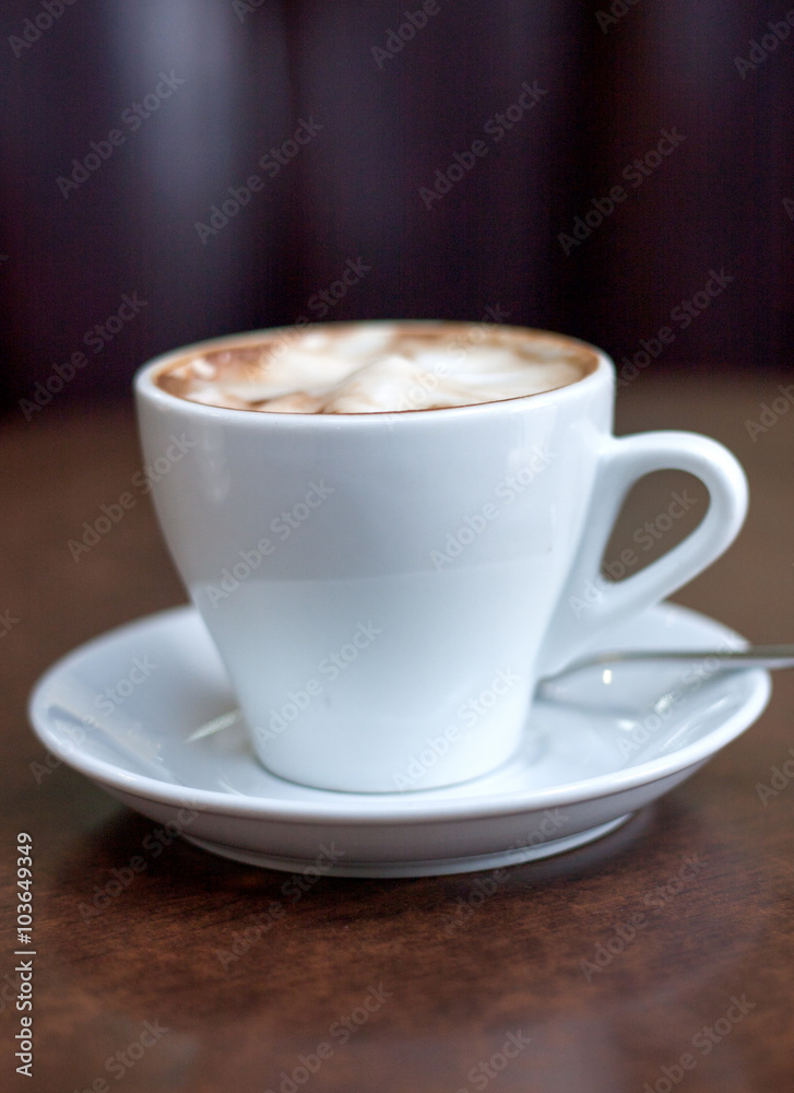 Cappuccino in a white cup on the table Cappuccino in a white cup on the table