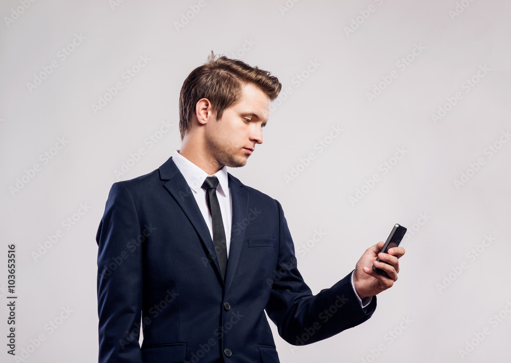 Hipster businessman with smartphone writing text message. Studio Hipster businessman with smartphone writing text message. Studio