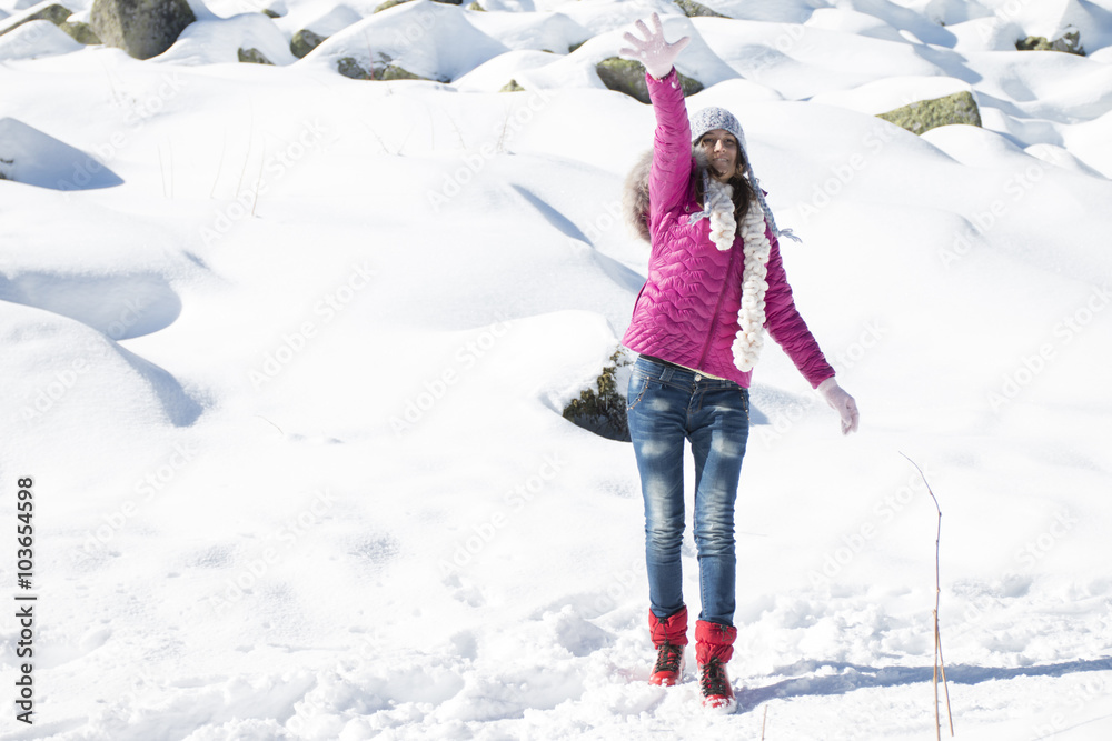A young girl plays with snow in winter A young girl plays with snow in winter