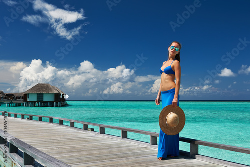 Woman on a beach jetty at Maldives