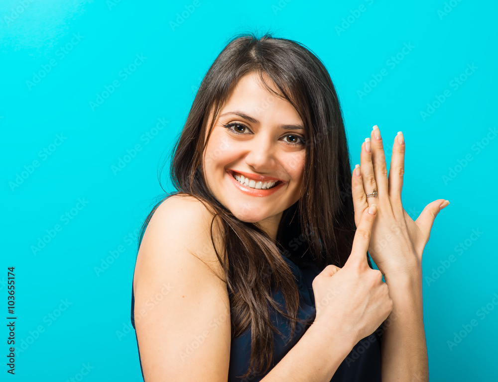 happy young woman showing on the a wedding ring happy young woman showing on the a wedding ring