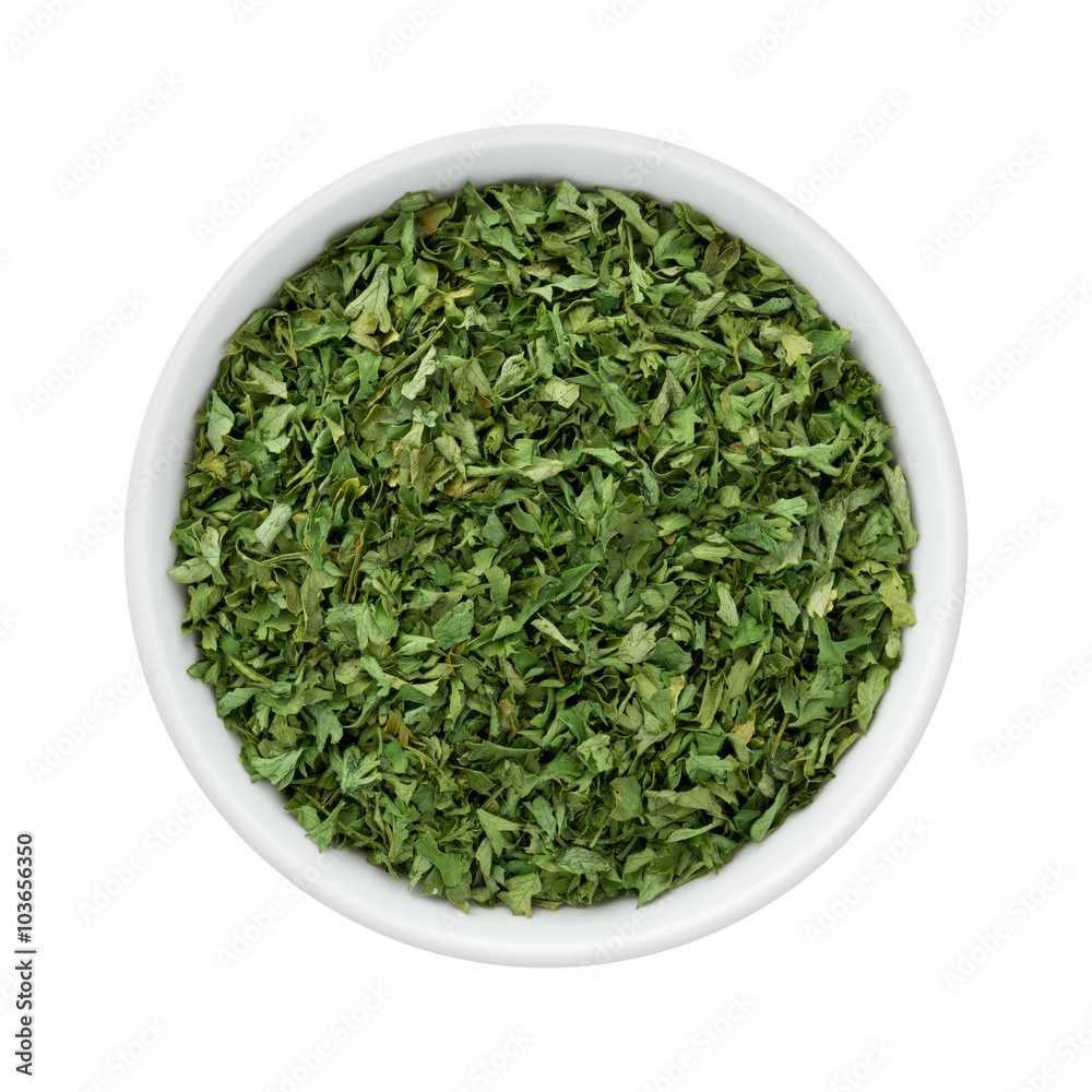 Dried Parsley Flakes in a Ceramic Bowl Dried Parsley Flakes in a Ceramic Bowl