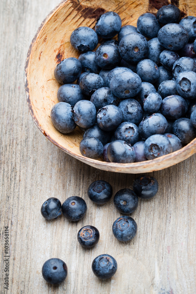 Blueberries in a bowl on a wooden table. Blueberries in a bowl on a wooden table.