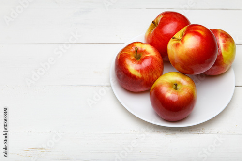Red apples on a white table