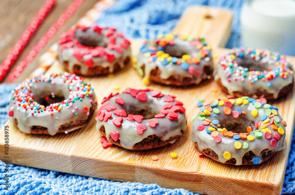 banana Donuts with icing and colorful sprinkles banana Donuts with icing and colorful sprinkles