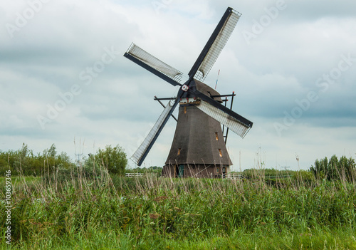 Windmill  green land and gray clouds