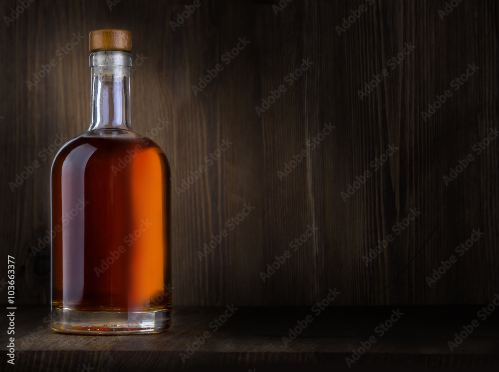 Bottle of whiskey on a wooden Bottle of whiskey on a wooden