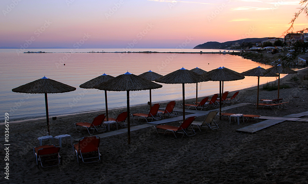 Wooden umbrellas and chairs at the beach Wooden umbrellas and chairs at the beach