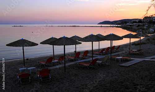 Wooden umbrellas and chairs at the beach