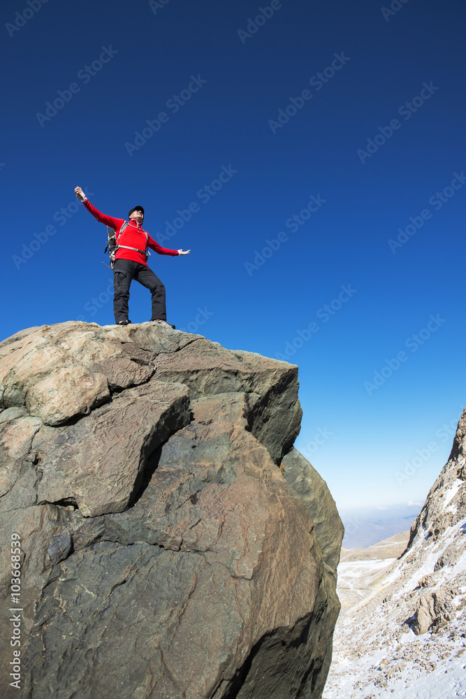Man on top of mountain