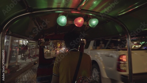Tuktuk moving along a street in Bangkok, Thailand. Such motorbike taxis are called tuktuks in Thailand.
