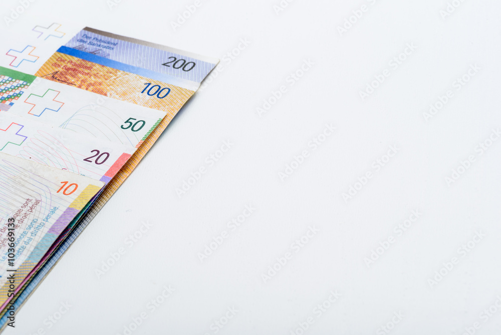 Suisse Francs Bills on White Table with Copy Space Suisse Francs Bills on White Table with Copy Space
