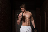 Young Bodybuilder Exercising Biceps With Dumbbells