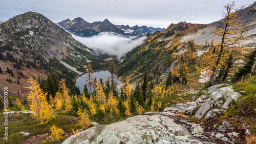 A small lake amidst the scenic autumn mountains shrouded in mist, HEATHER-MAPLE PASS LOOP TRAIL, Washington state