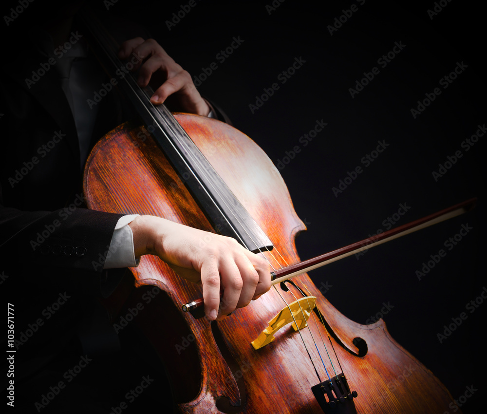 Man playing on cello on dark background Man playing on cello on dark background