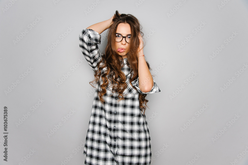Portrait of cute teen girl wearing stylish shirt isolated on gray background fashion for teenagers Portrait of cute teen girl wearing stylish shirt isolated on gray background fashion for teenagers