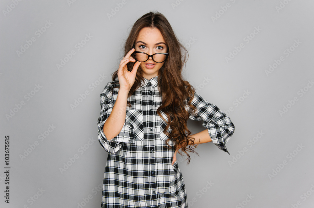 Portrait of cute teen girl wearing stylish shirt isolated on gray background fashion for teenagers Portrait of cute teen girl wearing stylish shirt isolated on gray background fashion for teenagers