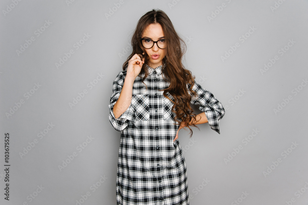 Portrait of cute teen girl wearing stylish shirt isolated on gray background fashion for teenagers Portrait of cute teen girl wearing stylish shirt isolated on gray background fashion for teenagers
