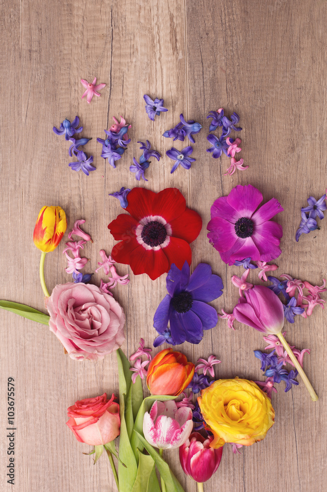 Scattered flowers on wooden background