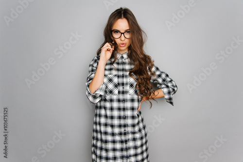 Portrait of cute teen girl wearing stylish shirt isolated on gray background fashion for teenagers