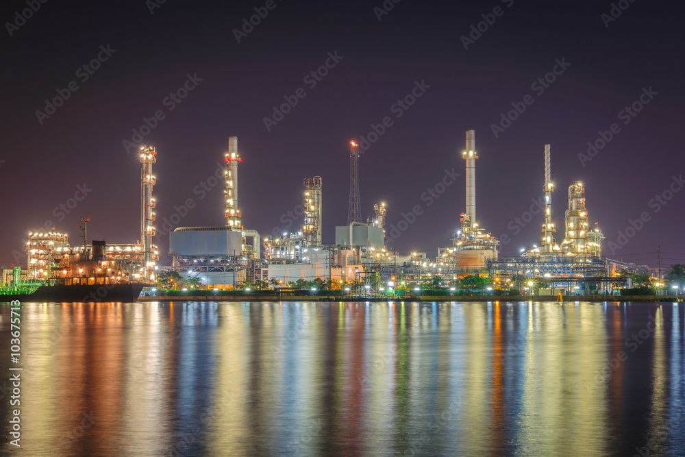 Oil refinery along the river at night time (Bangkok, Thailand)