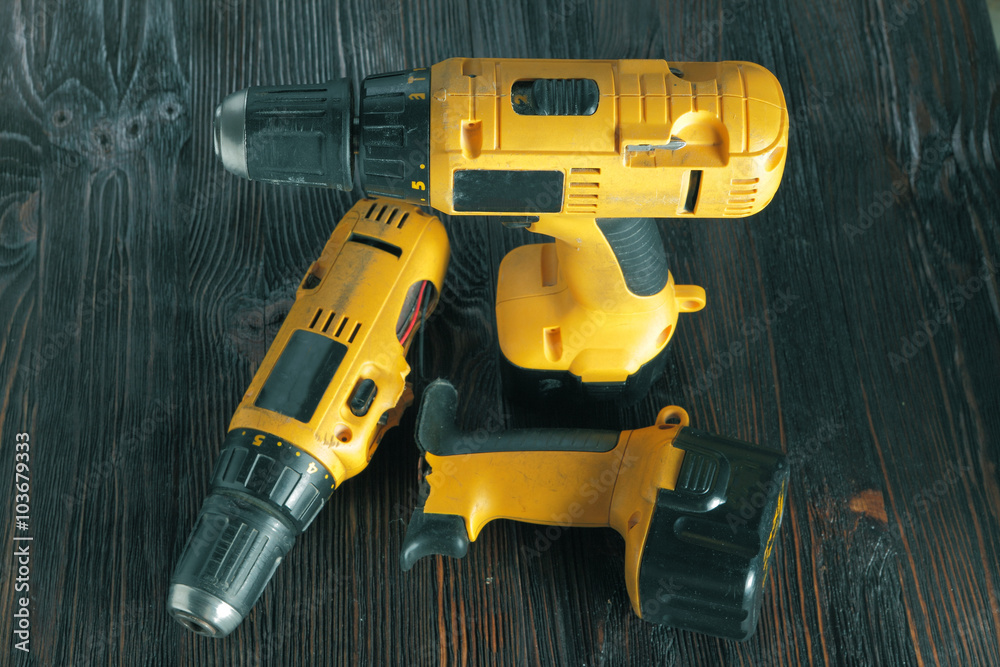 Electric drills on the wooden table Electric drills on the wooden table