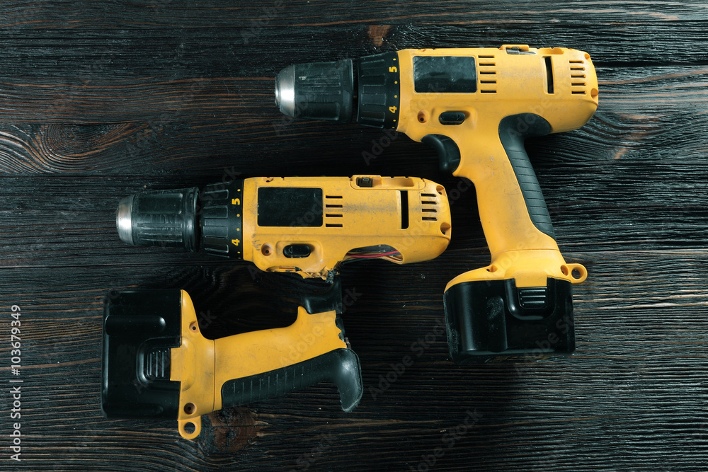 Electric drills on the wooden table Electric drills on the wooden table