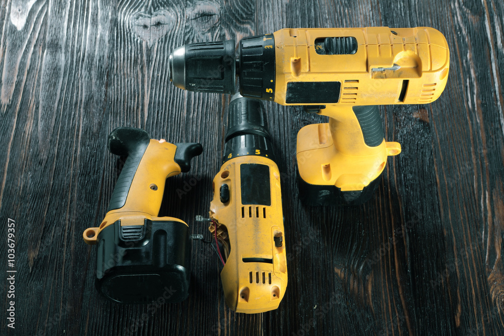 Electric drills on the wooden table Electric drills on the wooden table