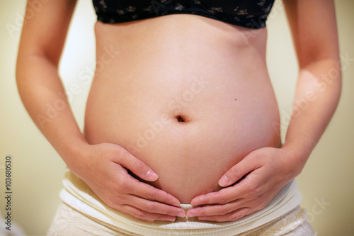 Belly of a pregnant woman on 12 week (3 month)