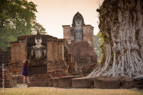 Tourist women take a photos at Sukhothai historical park, Mahathat Temple. Sukhothai ,Thailand