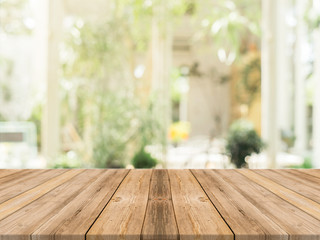 Wooden board empty table in front of blurred background. Perspective brown wood over blur in coffee shop - can be used for display or montage your products.Mock up for display of product.