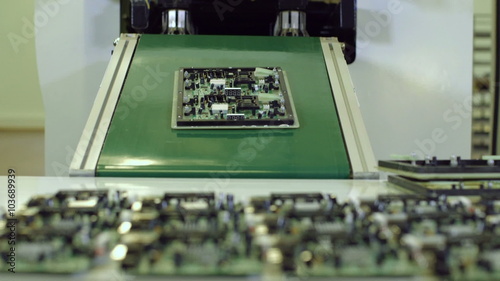 Factory assembly line production of PCBs for electronic equipment. automated machine manufacturing PCBs