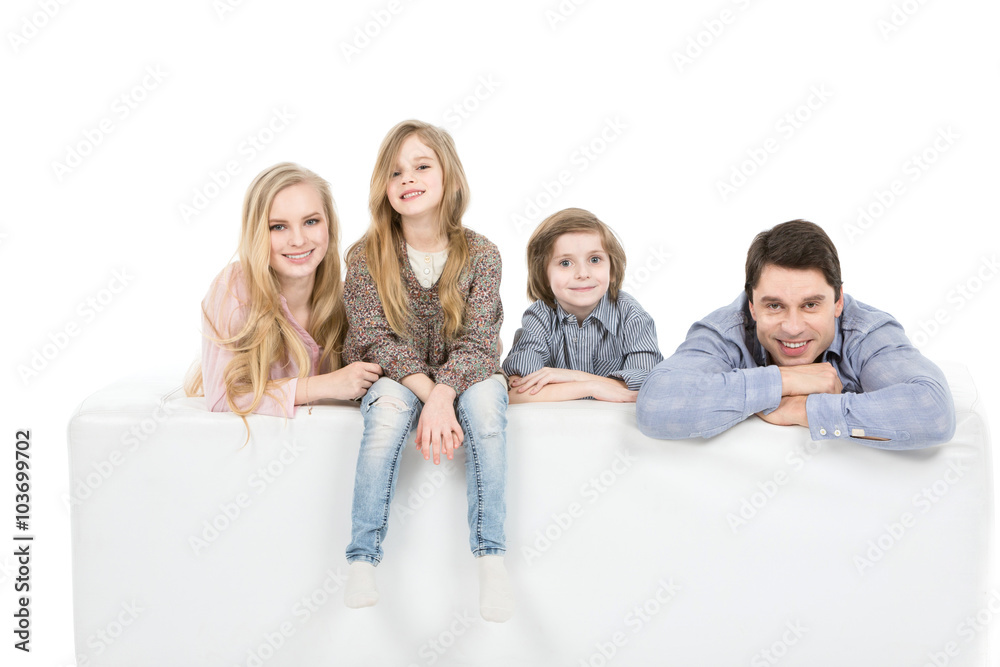 Happy family relaxing on sofa isolated on white. Happy family relaxing on sofa isolated on white.