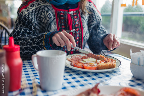 Young woman having english breakfast