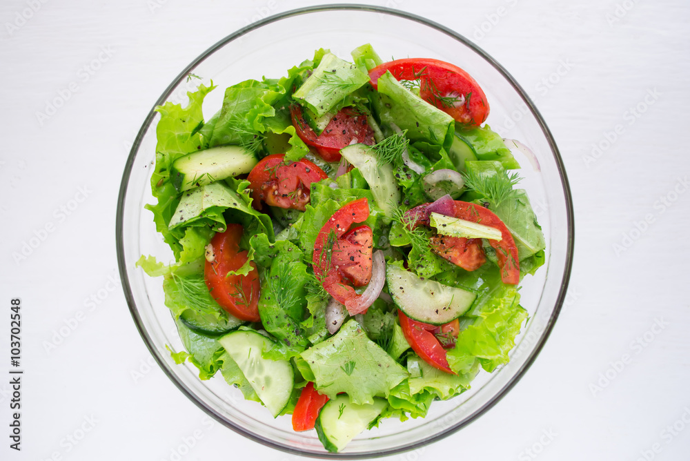 Vegetable salad of tomatoes, cucumbers and lettuce Vegetable salad of tomatoes, cucumbers and lettuce