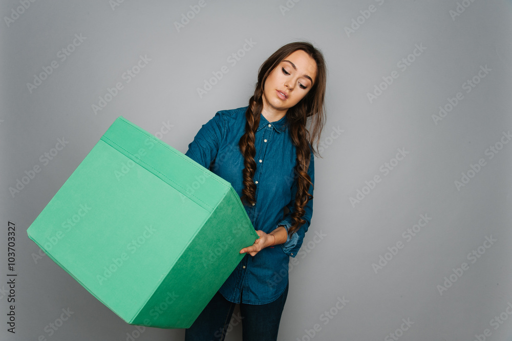 Attractive cute caucasian girl holding big square box in her hand ready to stock goods
