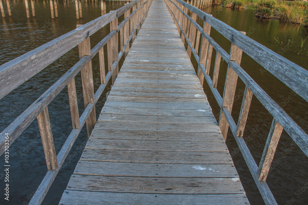 Fototapeta premium Wooden Bridge in lotus lake