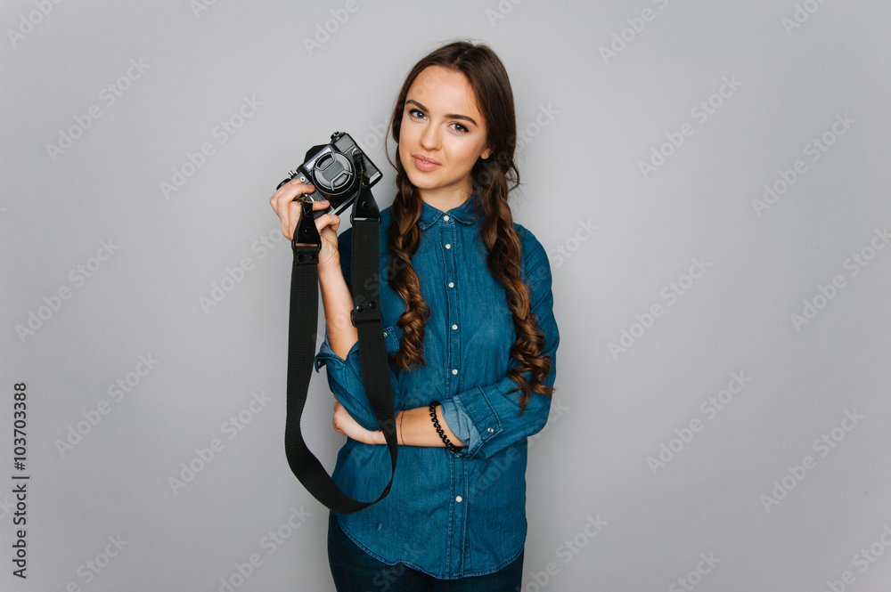 Portrait of cute teen girl making pictures to herself isolated on gray and studio background posing to the camera