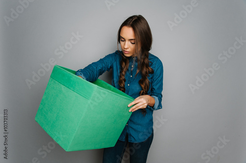 Attractive cute caucasian girl holding big square box in her hand ready to stock goods 