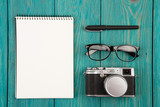 Notepad, camera, glasses and pen