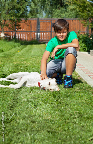 Boy petting his young labrador retriever dog © Arpad Nagy-Bagoly