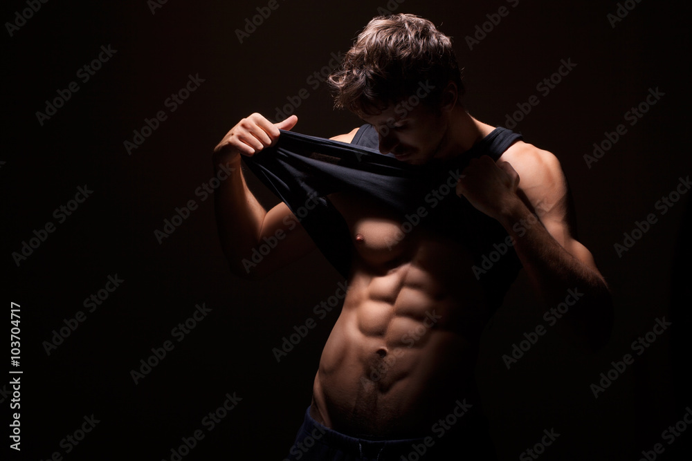 Muscular man with dark background