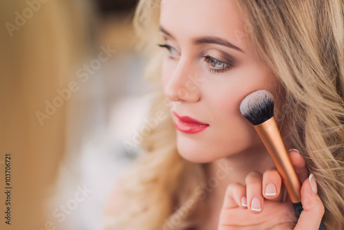 Makeup artist applying blusher