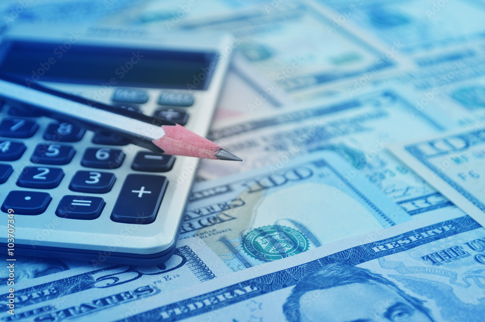 Pencil and calculator on dollar bank note money, Finance concept