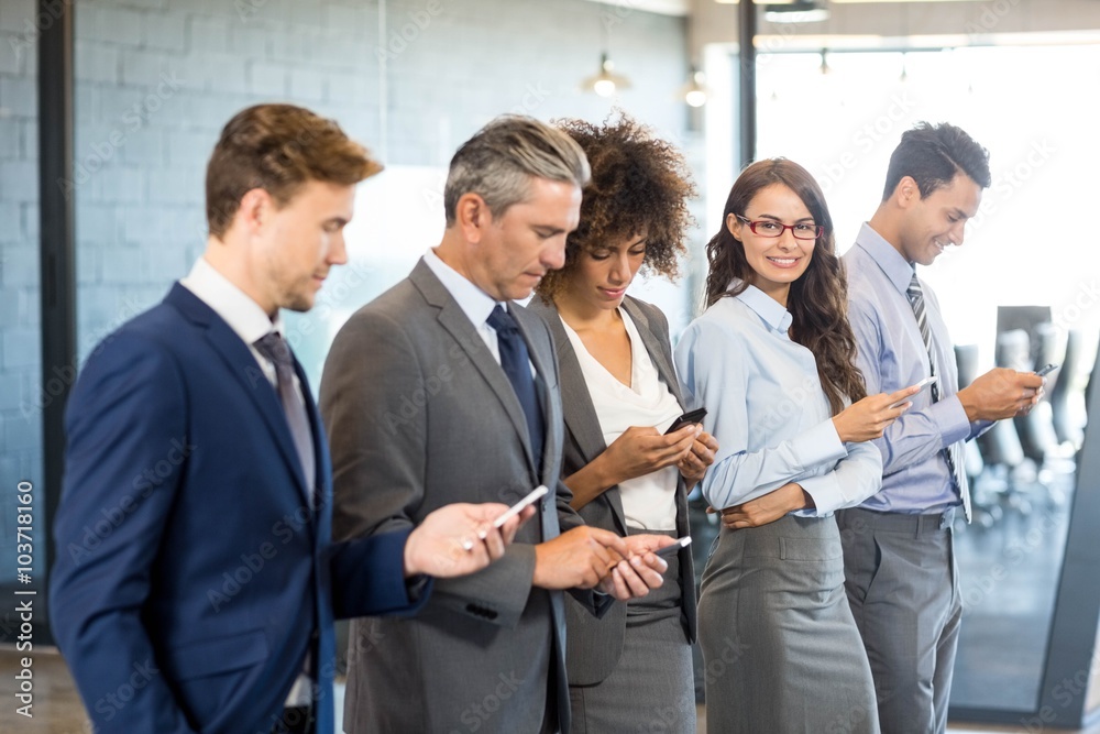 Business team using their mobile phone Business team using their mobile phone