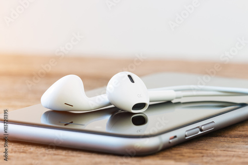 closeup phone and headphone device on table photo